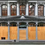 New York City, New York - June 11, 2020: Store closed during the COVID-19 pandemic, with boarded up windows to protect against looting as a result of anti-police brutality protests.